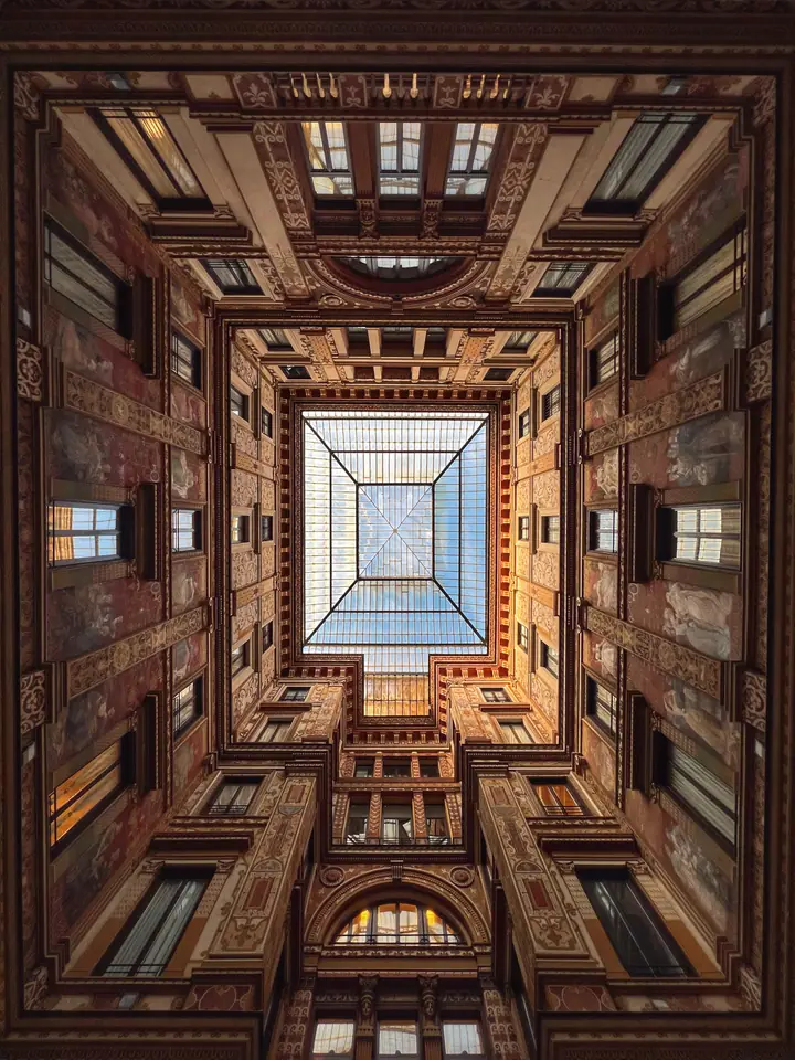 Upward architectural study with a glazed center and symmetrical ornament.